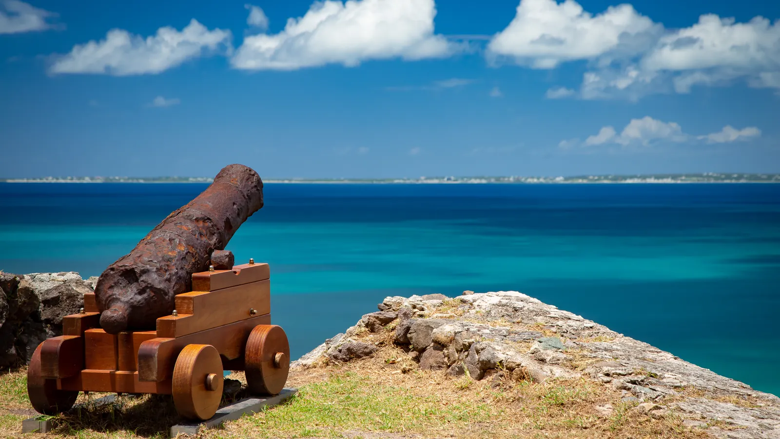 Historic cannon at Fort St. Louis overlooks the blue Caribbean Sea in Marigot.