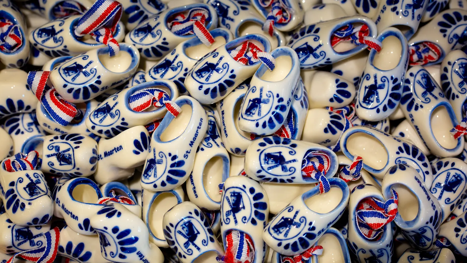 St. Maarten souvenir clogs decorated in blue, white, and red.
