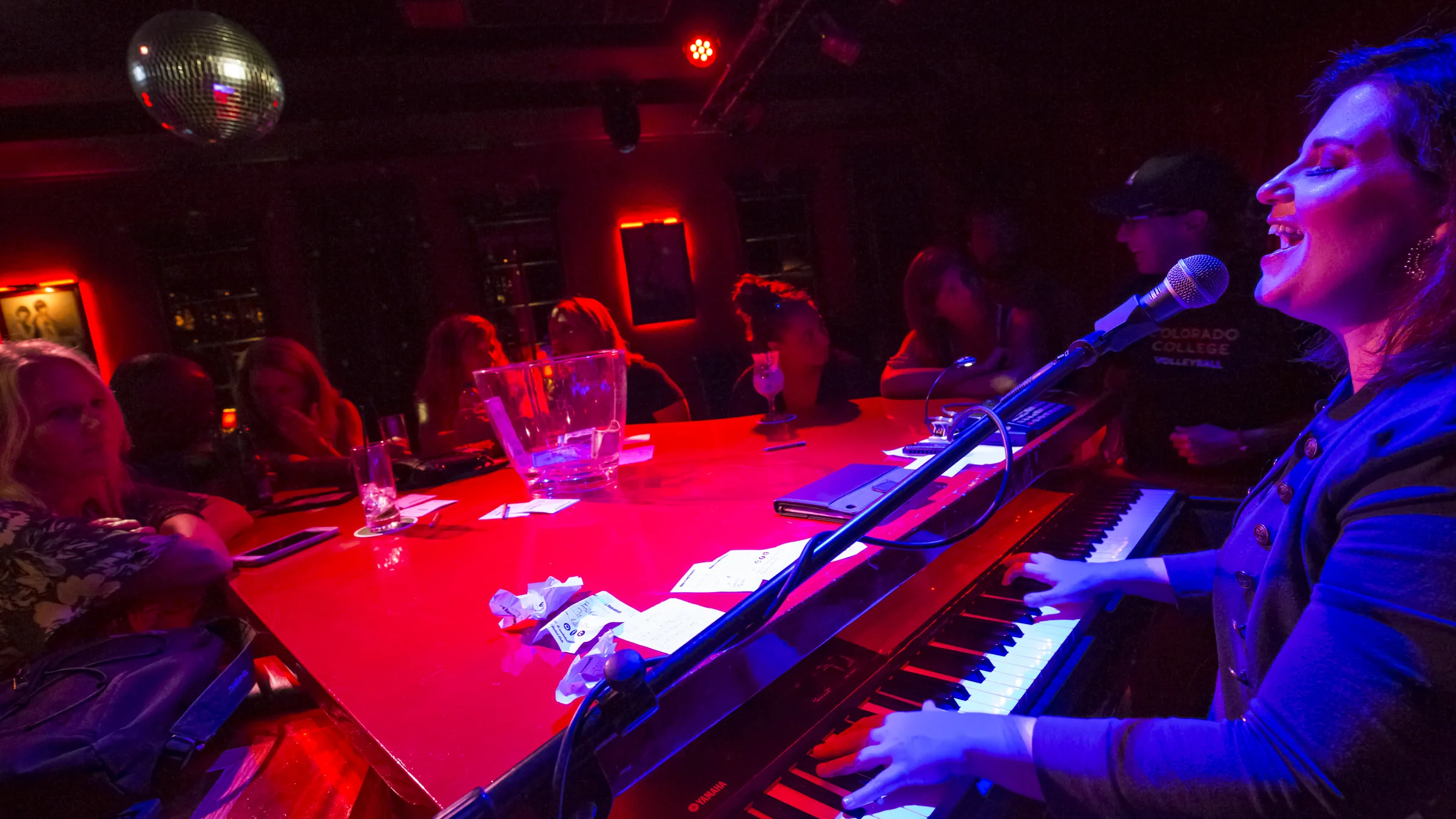 Singer performs at a lively piano bar in St. Maarten.