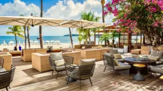 Terrace in the sun with bougainvilleas and view of boardwalk Philipsburg and Fort Amsterdam, St Maarten